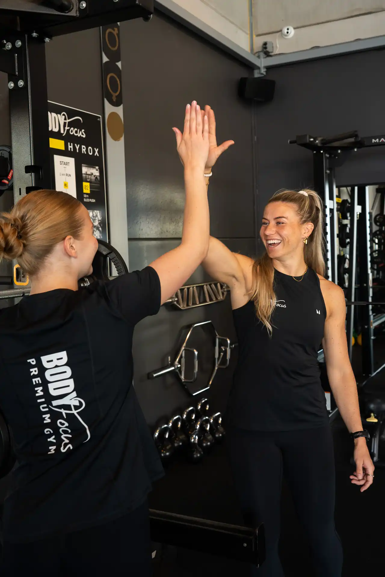 Body Focus trainer geeft een high five aan een lid na een succesvolle training